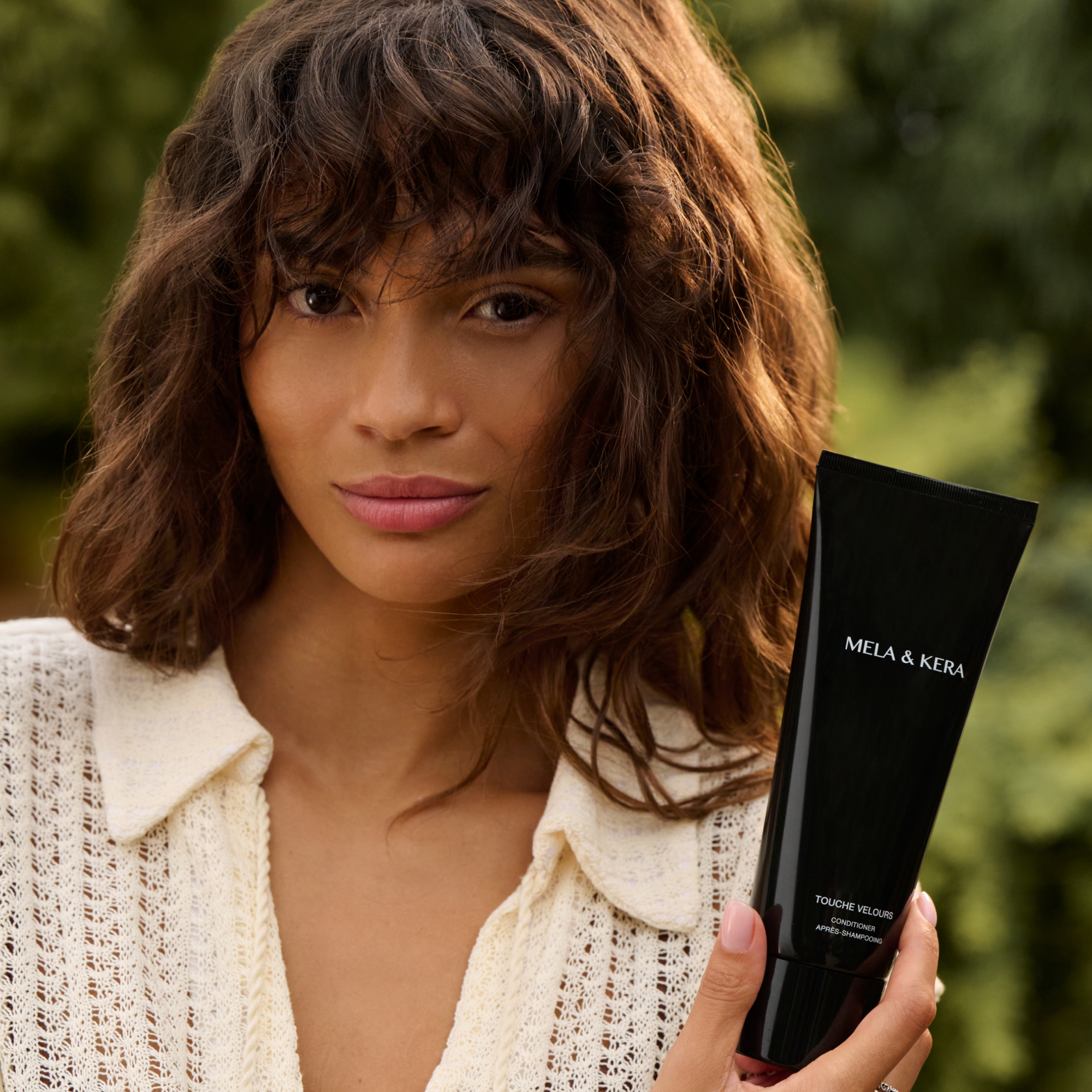 Model with velvety soft hair styled with Mela & Kera Touche Velours Conditioner