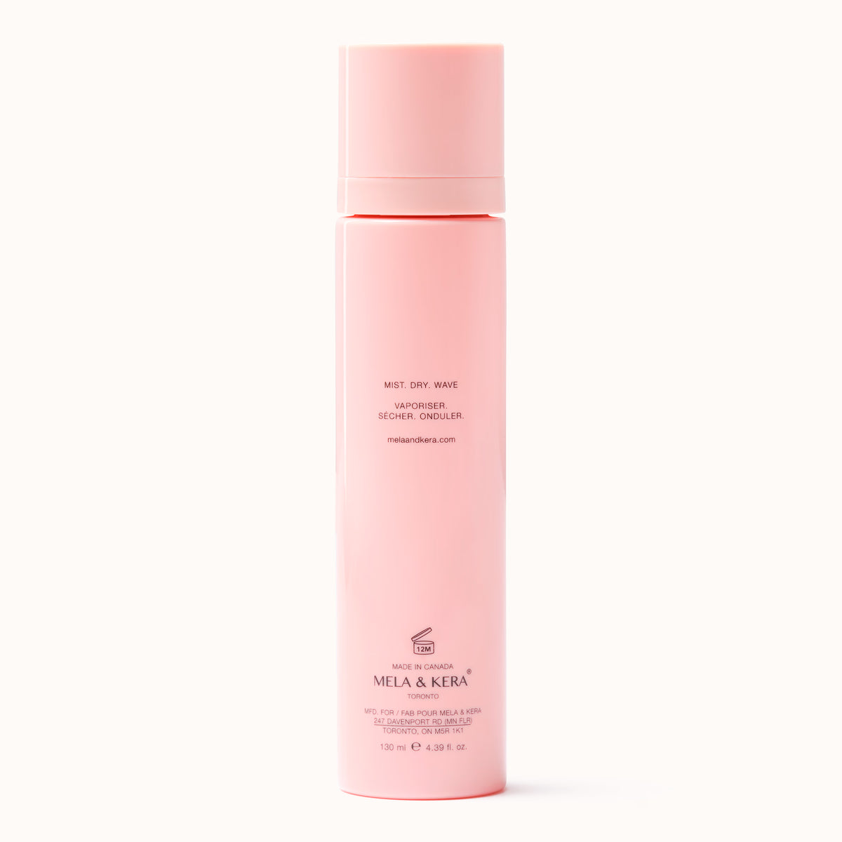 Pink wave foundation bottle with back label facing outward; Mela & Kera